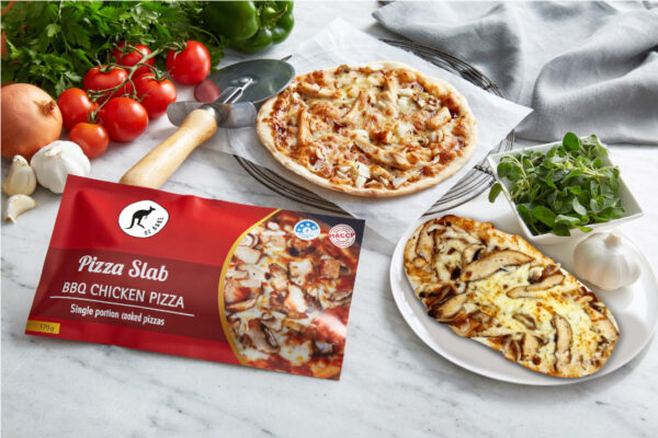 oz bake school canteen healthy bbq chicken pizza single ready to eat next to its' colourful pie warmer ready packaging