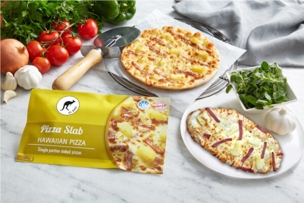 The halal Hawaiian pizza next to its bright yellow pie warmer friendly packaging. Perfect for your coffee shop, cafe or school canteen.