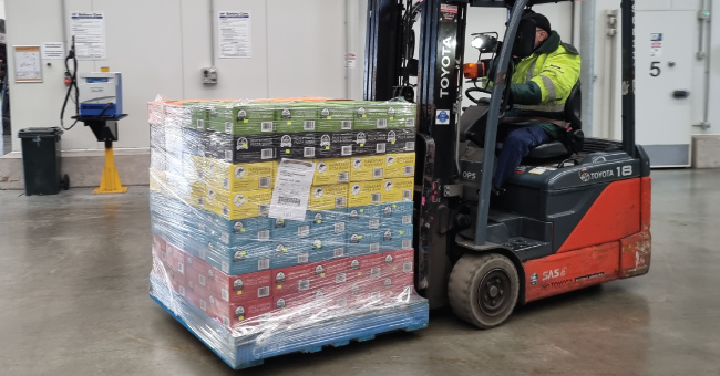fork lift carrying our ready made frozen pizza pallet
